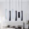 Modern hanging pendant lights over kitchen island in a home setting.