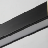 new-style-office-side-view Black picture frame edge with contrasting wood corner detail on a grey background.