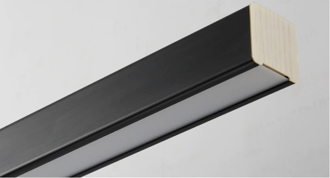 new-style-office-side-view Black picture frame edge with contrasting wood corner detail on a grey background.