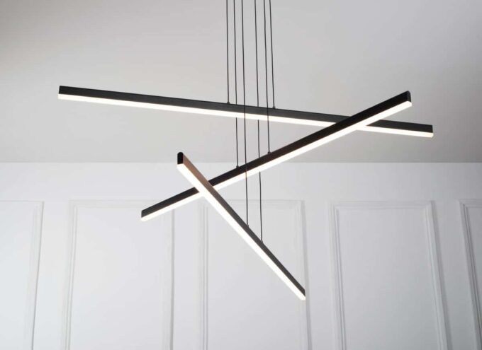 MD19103-3-4-small Modern LED pendant light fixture with a geometric design, hanging in a room with white walls.