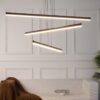 MD19103-3 small Modern glass pendant lights with copper fixtures hanging over a minimalist kitchen island