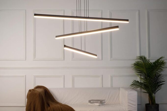 MD19103-3 small Modern glass pendant lights with copper fixtures hanging over a minimalist kitchen island