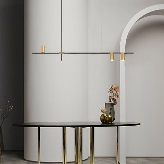 Modern minimalist interior with elegant pendant lighting and round table.