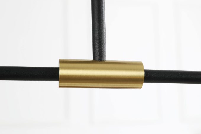 MC1541R-2 (1) Close-up of a gold-colored metal tube connector joining black rods.