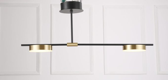 MC1541R-2 (4) Modern black and brass pendant light fixture against a white panelled wall.