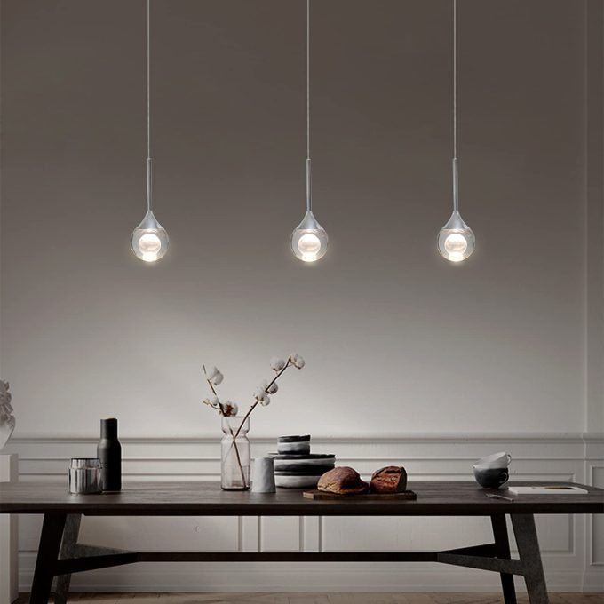 61LFZZjWjJL._AC_SL1500_ Modern pendant lights over a wooden dining table with decorative items.