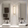 Modern bathroom interior with twin sinks, wall mirrors, and sconce lighting.