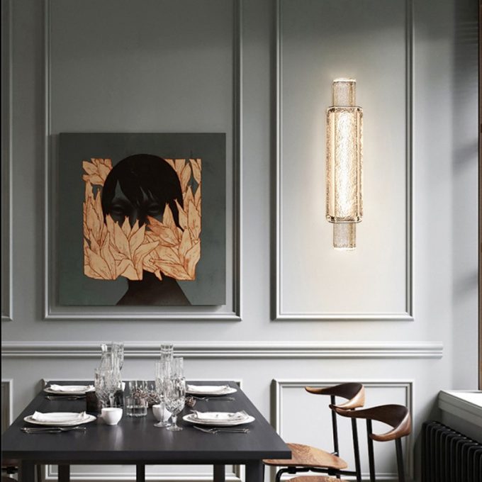 Elegant dining room with modern art and designer lighting fixture.