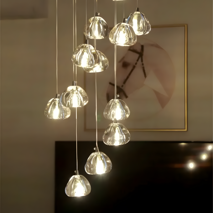 1 Modern chandelier with multiple hanging glass lights, elegantly illuminating a room with a framed abstract art piece in the background.