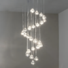 4 Modern multi-pendant light fixture with cascading design and glowing bulbs, ideal for contemporary interiors and sophisticated decor.