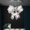 5 Modern glass chandelier in a contemporary room with white chairs.