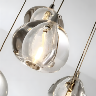 Modern glass pendant lights with exposed bulbs suspended from the ceiling, providing a stylish contemporary lighting solution.