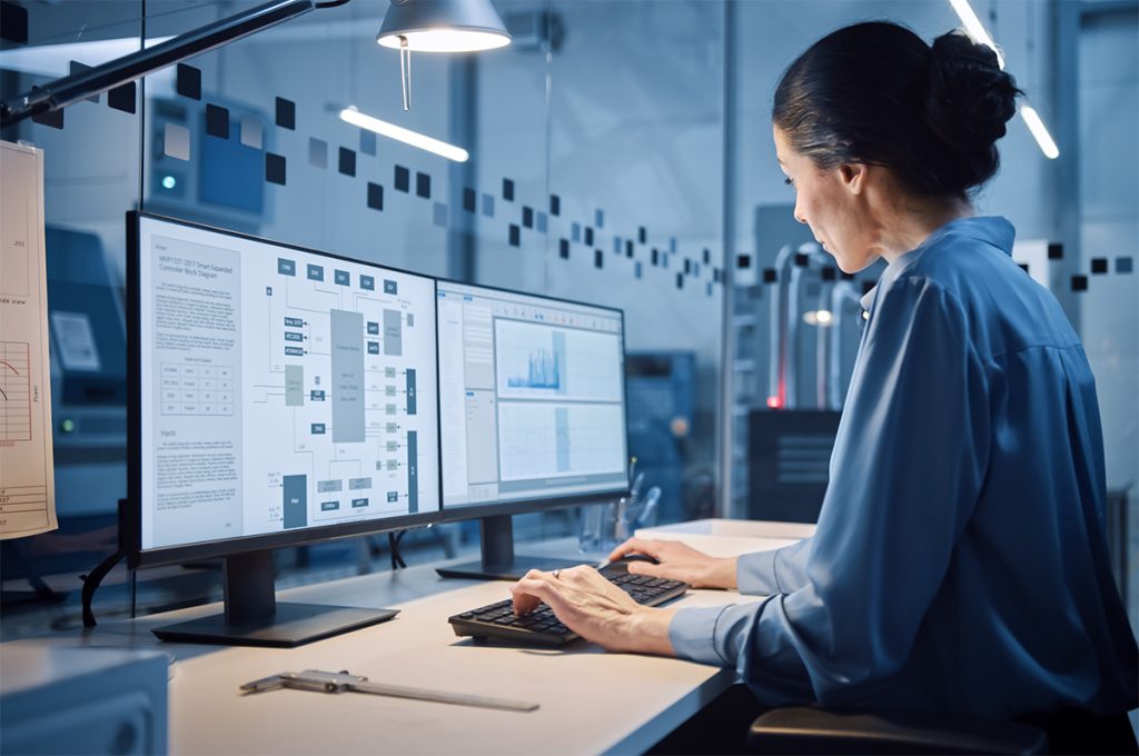 Woman working on computer desk with task lighting