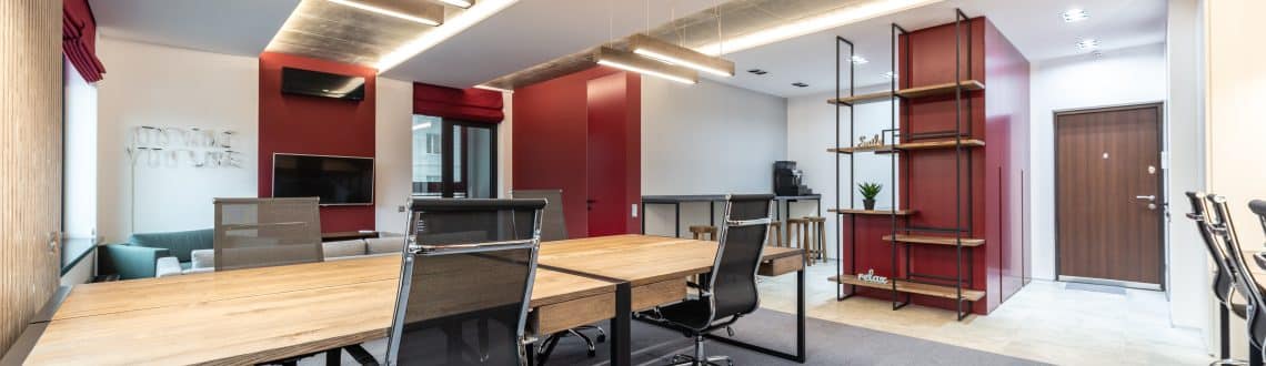 Minimalist home office with a sleek wooden desk, modern chair, and large window for natural light.