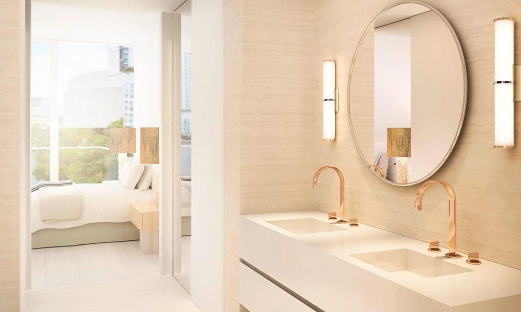 Hotel Bathroom With Large Mirror and Wall Lights