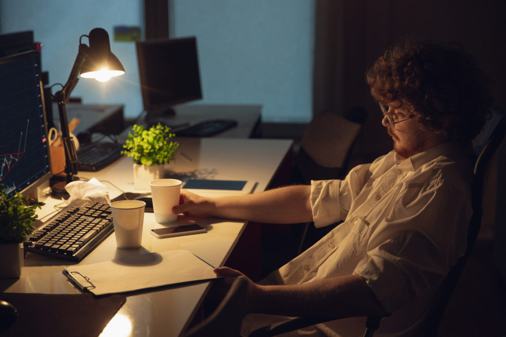 man working office alone during coronavirus covid 19 quarantine staying late night