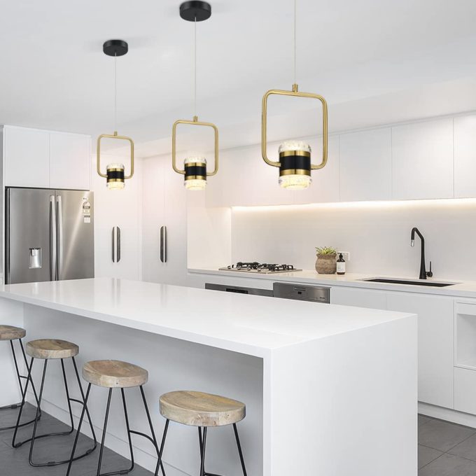 51l7EmyVLvL._AC_SL1000_ Modern white kitchen interior with gold pendant lights and bar stools.