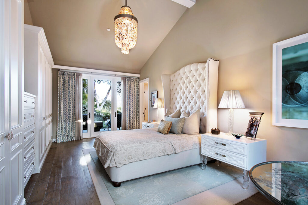 small chandelier hanging in a traditional style bedroom 