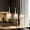 Elegant glass pendant lights over modern dining table, interior design.