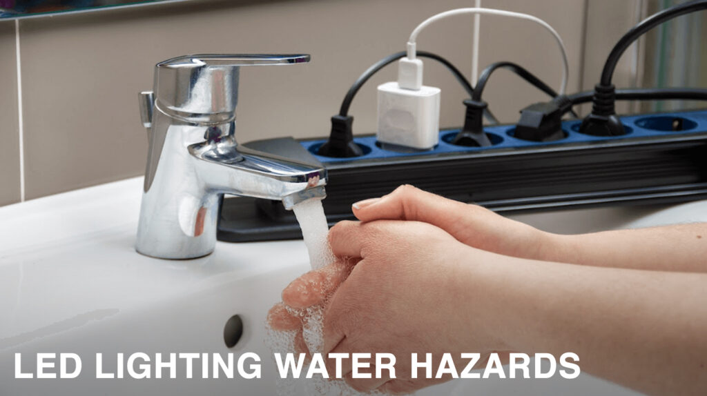Someone washing hands near a power strip with the words "LED Lighting Water Hazards"