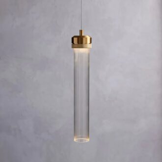 Elegant pendant light with brass accents against a grey backdrop.