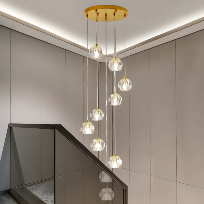 4 Elegant modern chandelier with multiple hanging crystal pendant lights, illuminating a contemporary stairway with glass railing.