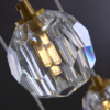 6 Crystal pendant light with LED bulb, close-up, showcasing elegant geometric design and warm illumination.