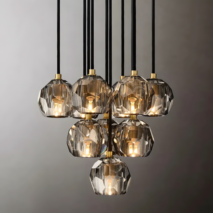small (2) Modern geometric crystal pendant chandelier with warm lighting, black and gold accents, against a neutral background.