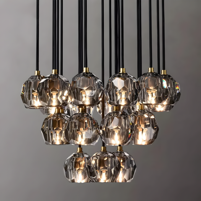 small (4) Modern crystal chandelier with multiple pendant lights, black cords, and gold accents, illuminating a stylish interior space.