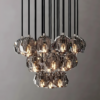 small (6) Modern multi-light crystal chandelier with geometric design and decorative warm lighting, hanging against a neutral background.
