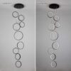 AC_SL1500_ Modern pendant light fixture, off and on view, showcasing circular LED rings hanging from ceiling.